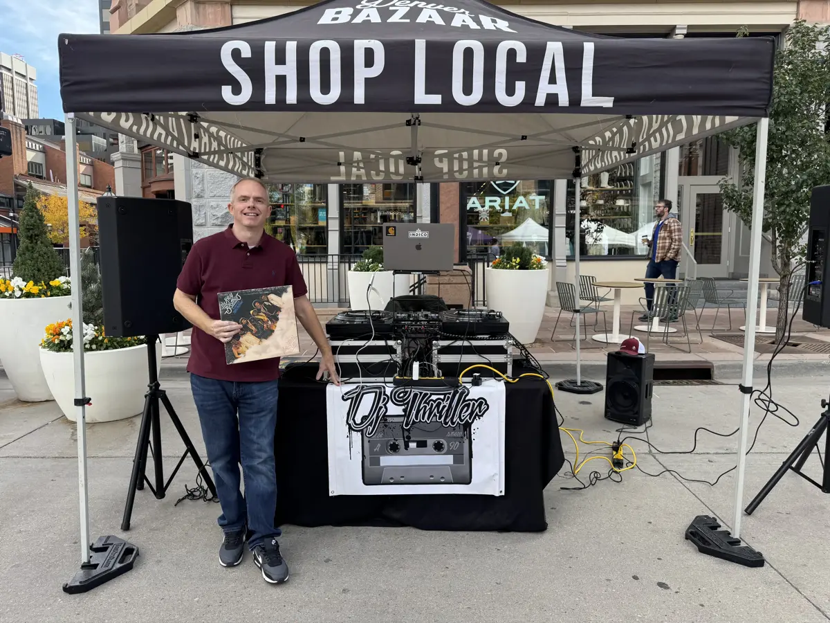 DJ Thriller at Shop Local community event with branded DJ booth setup