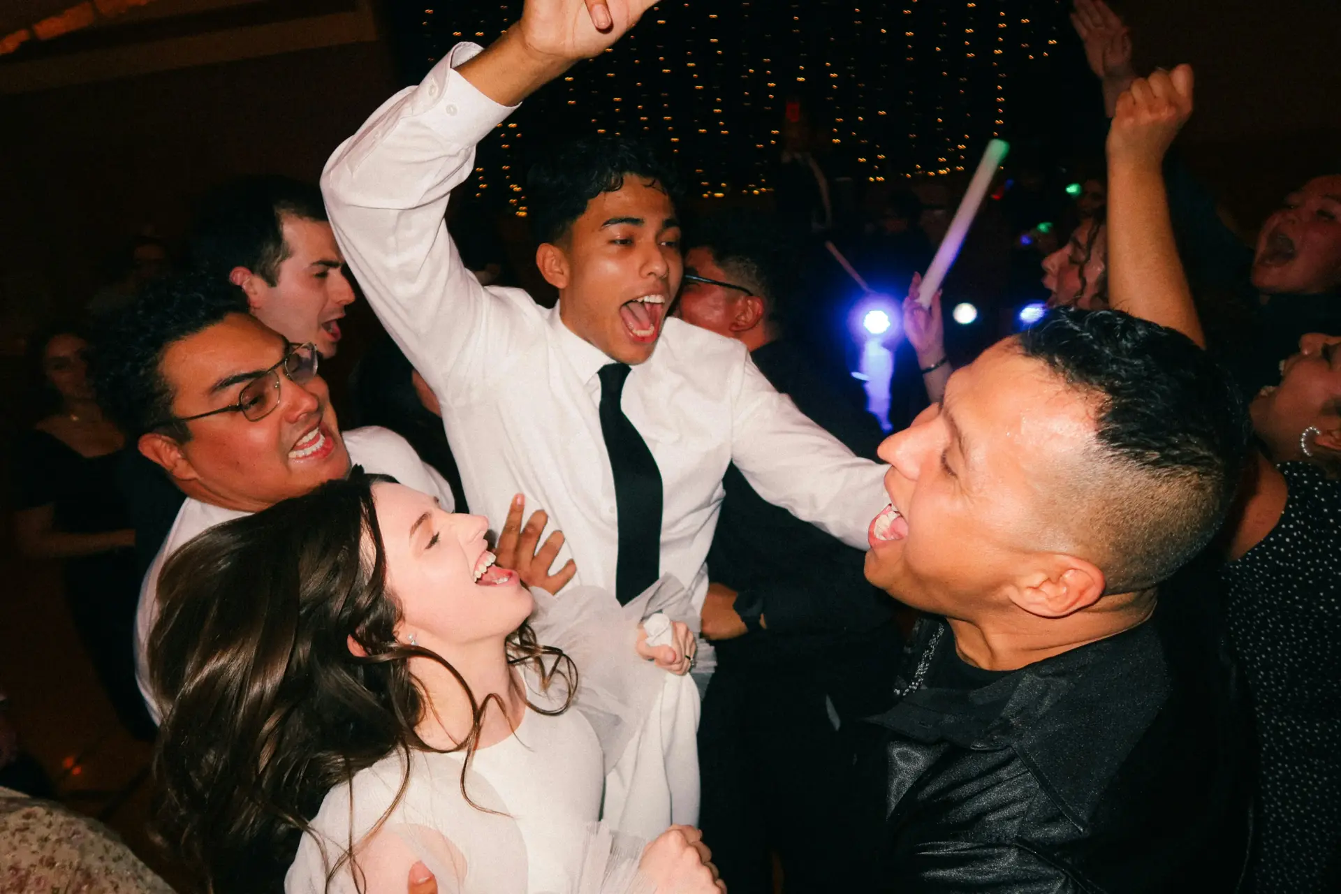 Bride and bridesmaids dancing together at Colorado Springs wedding reception