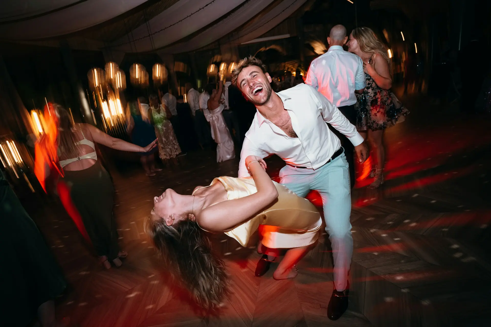 Panoramic view of packed wedding dance floor with DJ Thriller entertaining guests across Colorado